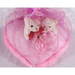 Valentine Couple Teddy Bears sitting on a pink plush heart covered with net